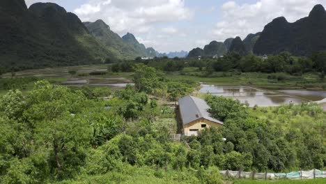 aerial: beautiful chinese farming village in karst mountain landscape