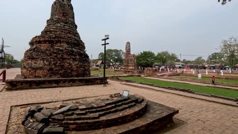 visitors walk around historic temple ruins