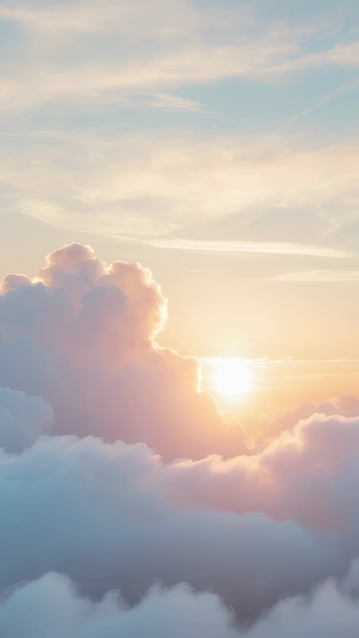 Vertical video: Lifting billowing clouds under rising sun above dawn horizon, reflecting pastel sky