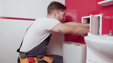 a-professional-plumber-in-the-bathroom-inspects-the-water-audit-all-bad