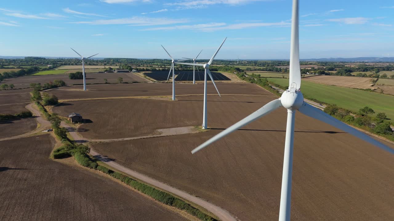 Aerial view showing wind power and solar arrays across farmland landscape, England, United Kingdom