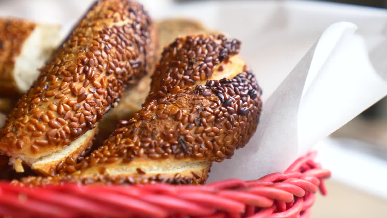 Sesame bagels in a red basket