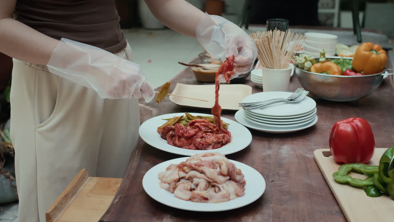 Hands of People Cooking during Barbecue