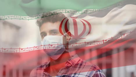 Animation-Der-Iranischen-Flagge,-Die-Während-Der-Covid-19-Pandemie-über-Einem-Mann-Mit-Gesichtsmaske-Winkt