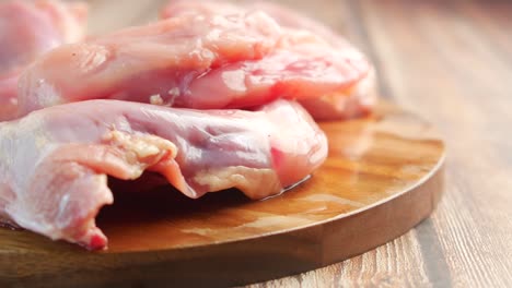 raw chicken pieces on wooden cutting board