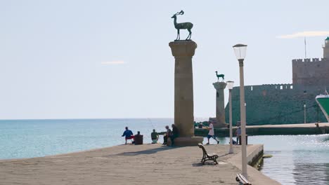 rhodes deer statues stand at the entrance to the port of mandraki harbor on the greek island of rhodes