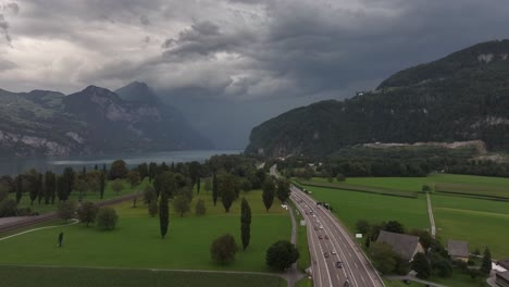 aerial view of cars driving through the main road near the walensee lake in weesen, st