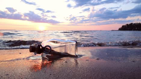 message in the bottle against the sun setting down