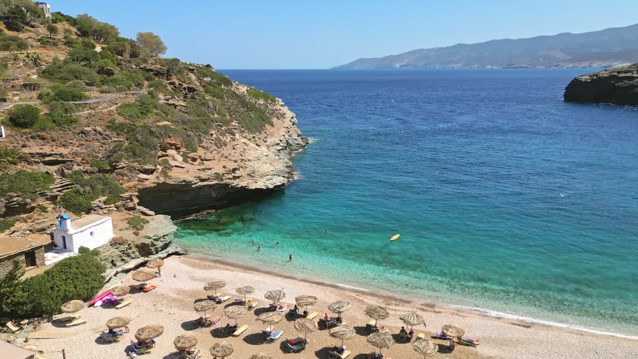 Aerial drone video of iconic turquoise and sapphire bay and beach of Andros, Cyclades, Greece