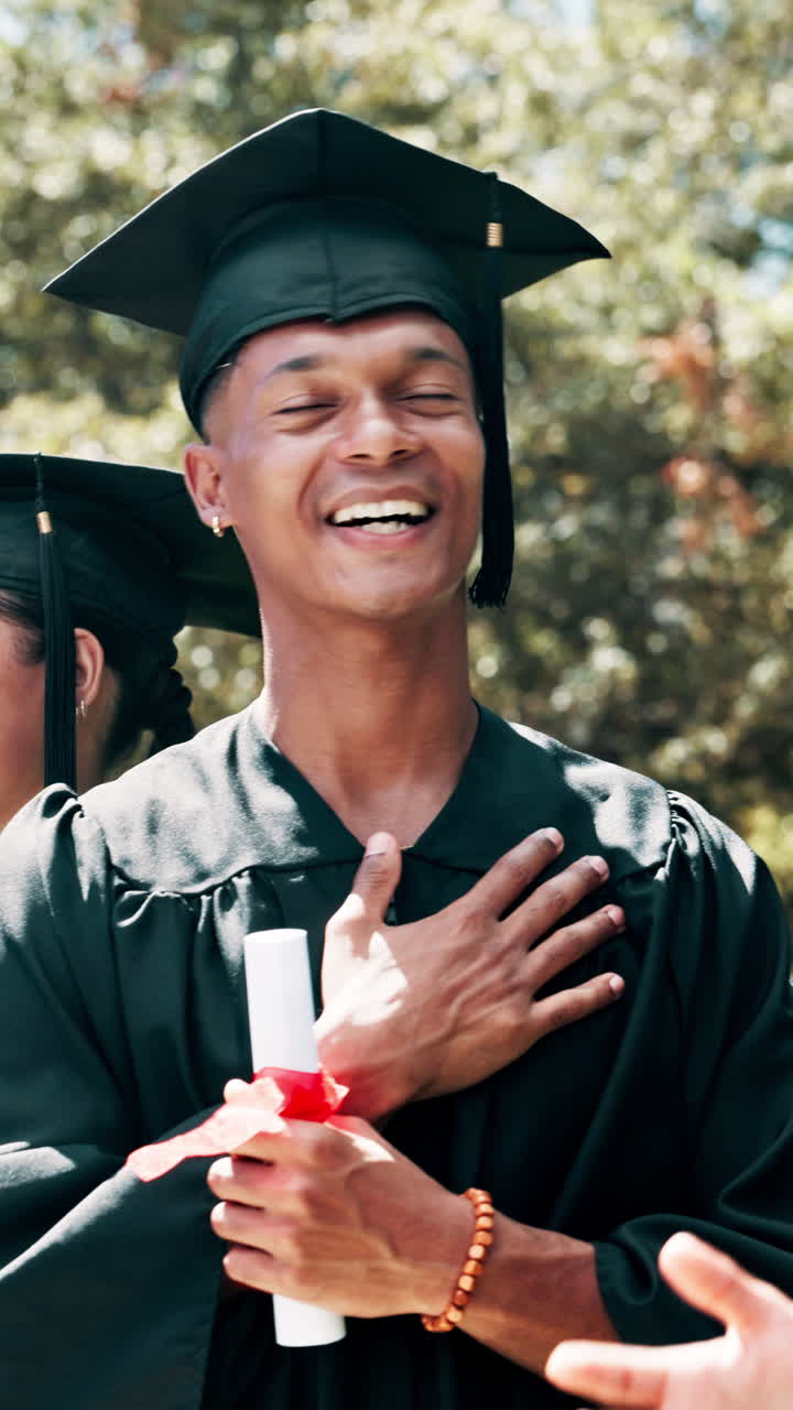 Happy Young Man Receiving Diploma at Graduation Ceremony
