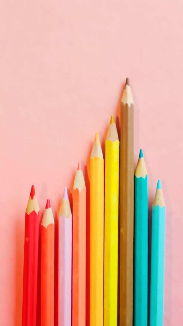Colorful Pencils Arranged on a Pink Background
