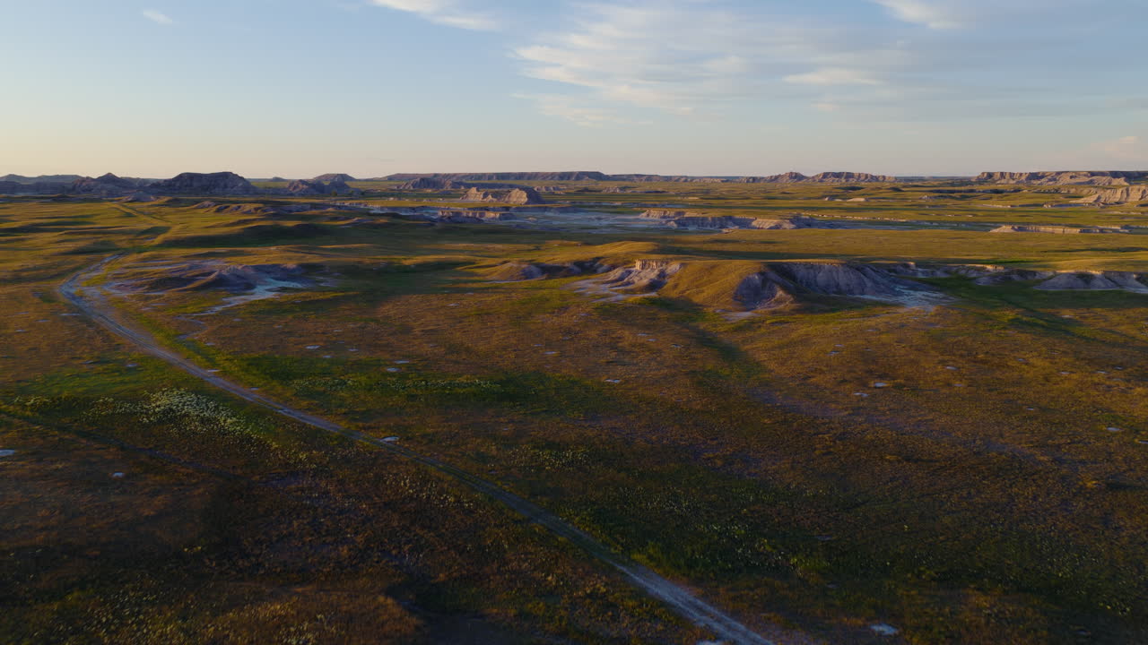 Flying Across Harsh Badlands Formations in Glowing Sunset Colors