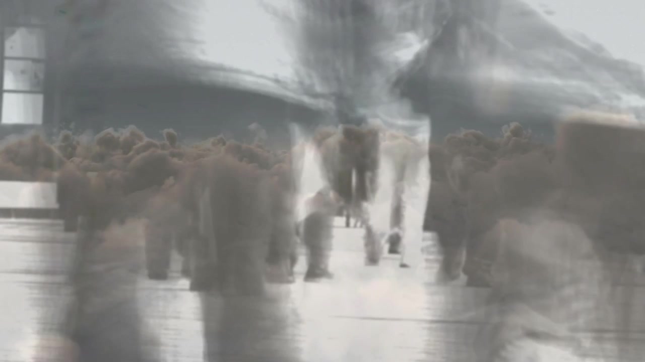 Commuters commuting to work walking along station plaza, flock overlay drifting and obscuring shoes