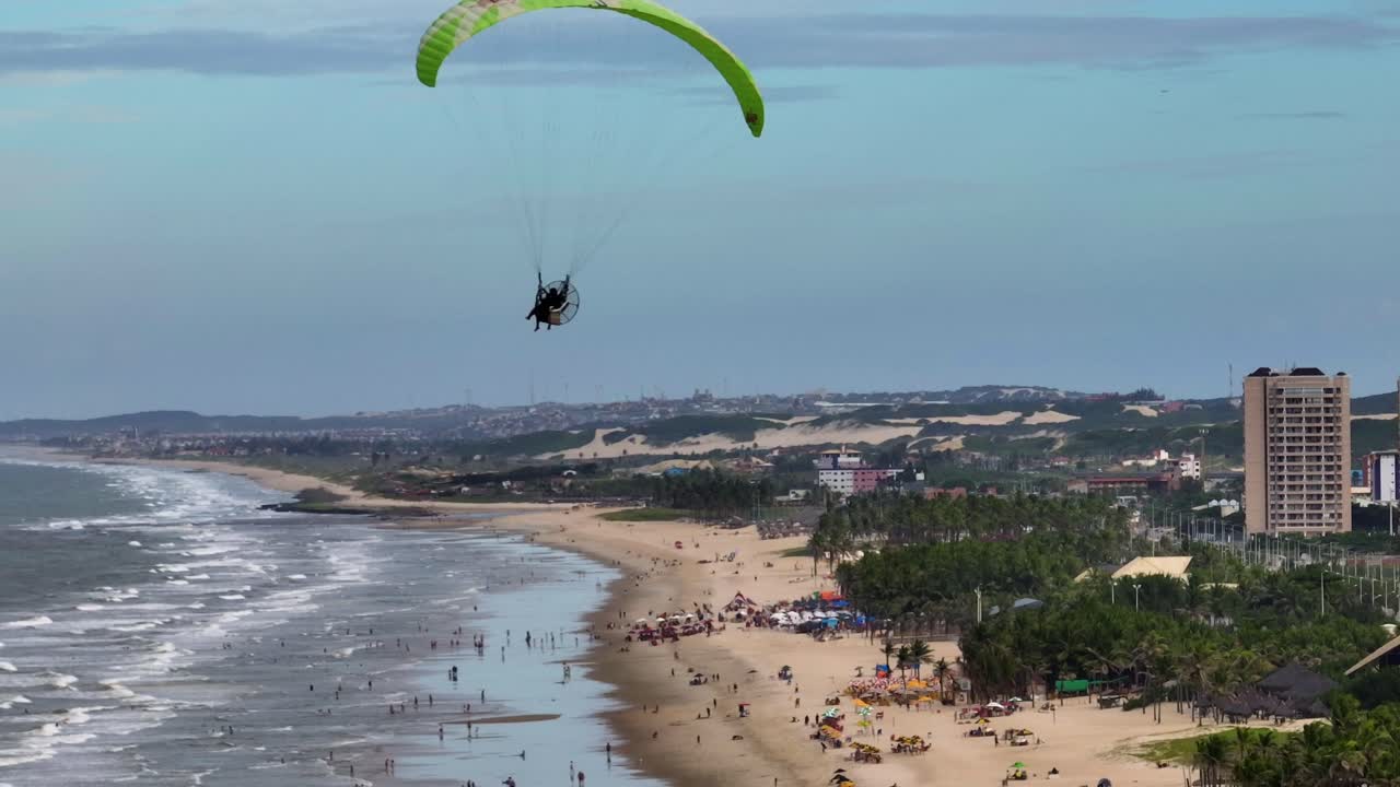 Paraglider soars over Fortaleza's Futuro Beach, offering a stunning aerial view