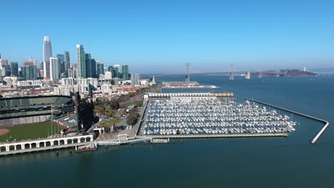 aerial view of att oracle park baseball stadium, bay bridge and downtown san francisco shot in 4k high resolution