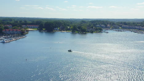 drone aerial shot of a pontoon boat pulling into the marina on lake norman