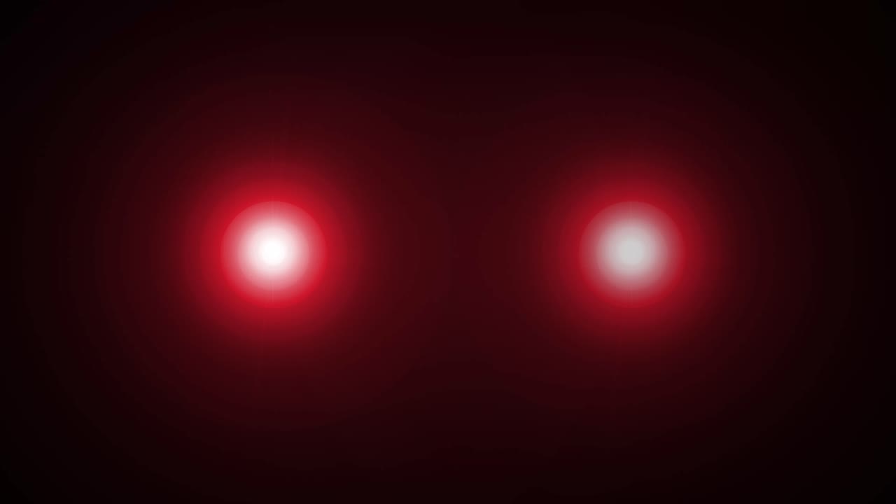 Yeux rouges brillants clignotant dans l’obscurité