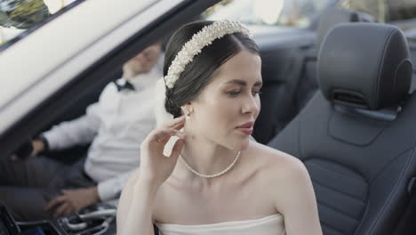 bride and groom in a luxury convertible
