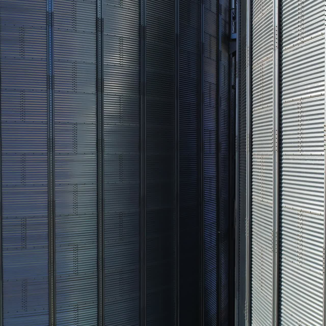 Aerial view of metal grain elevator in agricultural zone. Grain warehouse
