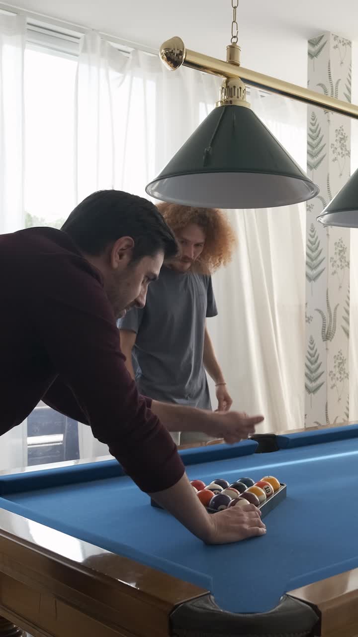 Happy black woman playing pool game with friends at home