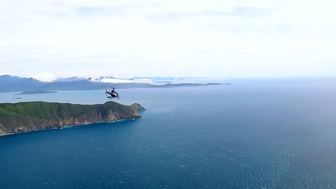 Air to air helicopter shot flying along the Cook Strait and Marlborough sounds, New Zealand