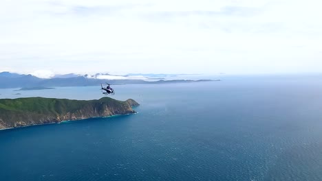 air to air helicopter shot flying along the cook strait and marlborough sounds, new zealand