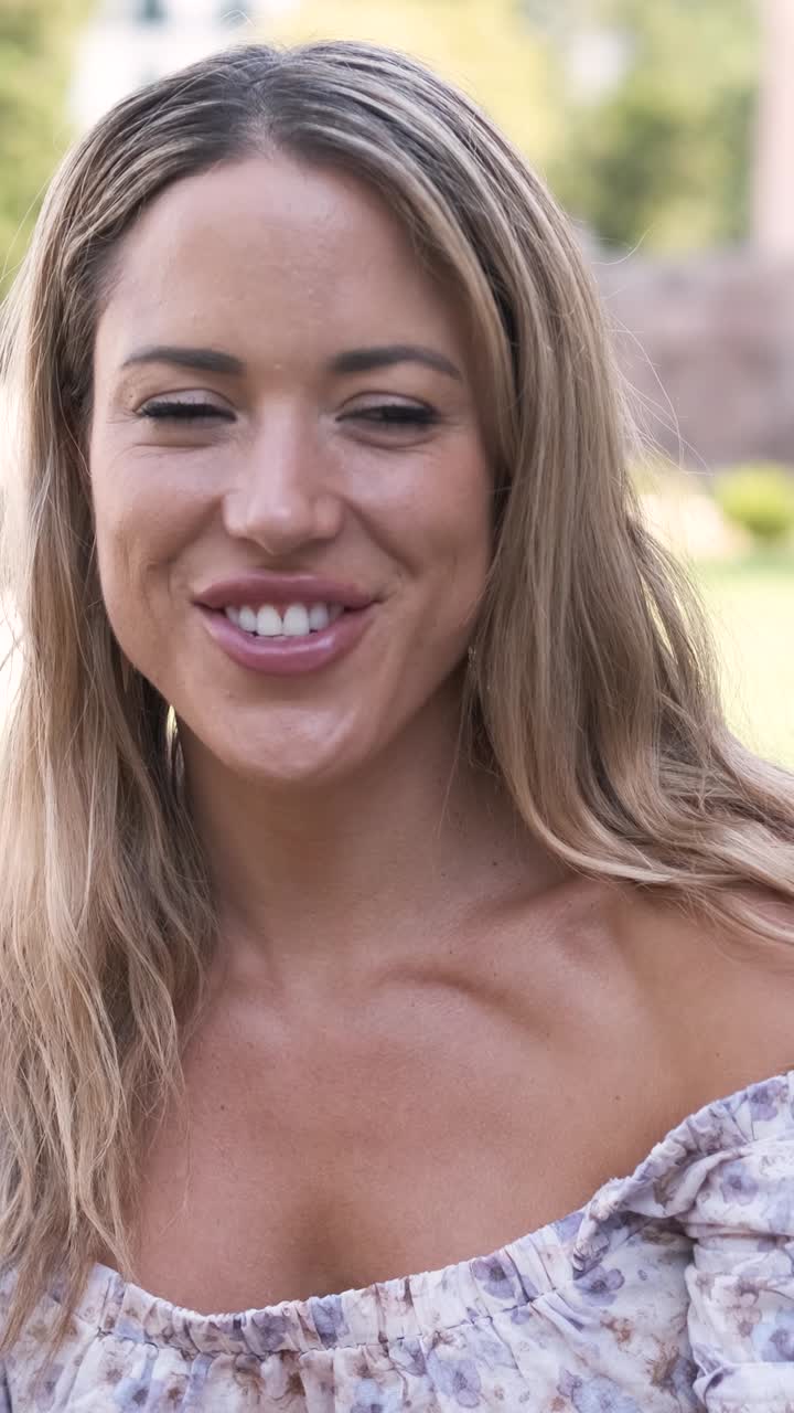 Happy woman listening to man talking at city park during daytime