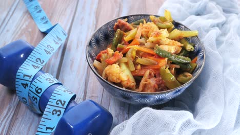 healthy vegetable stir-fry with fitness accessories