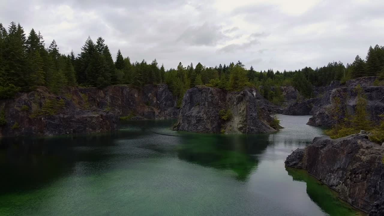 Aerial drone shot panoramic of a green lake in Texada Island, British Columbia Canada
