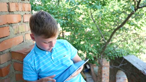boy using a tablet outdoors