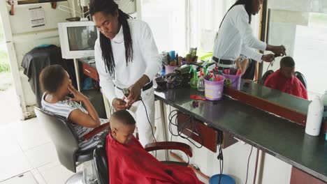 african man cleaning african boy hair