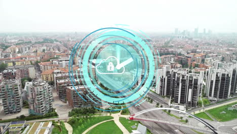 animation of clock over padlock in cloud and aerial view of modern city against sky