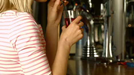 woman being served drink at the bar