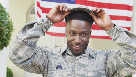 portrait of african american male soldier smiling over american flag