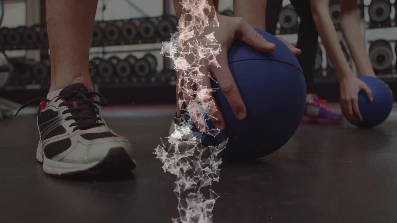 Gym duo shifting weight, doing footwork for training, using blue medicine ball, mesh hiding center