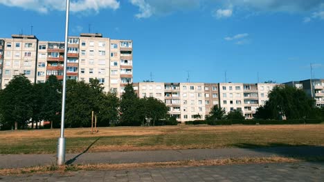 old chernobyl style block apartments in the distance with empty stadium and football gates.