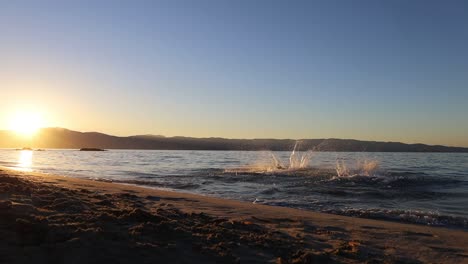 Two-man-running-into-the-mediterranean-sea-with-sunrise-in-the-background