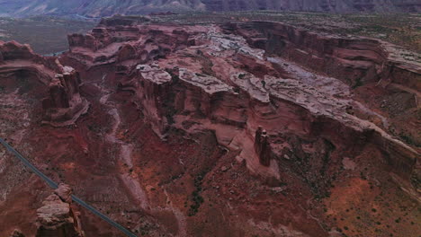curvy lines of rocks in the amazing canyon. car road going through the territory between the rocks. aerial perspective.