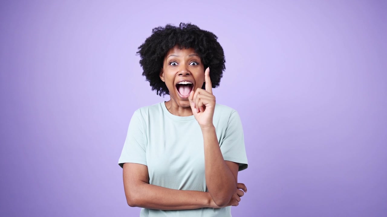 African American Woman Thinking, Then Gets an Idea and Smiles