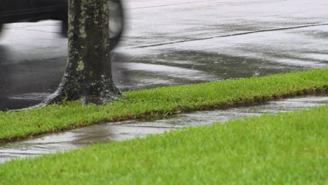 large car tires move on wet street while raining in slow motion