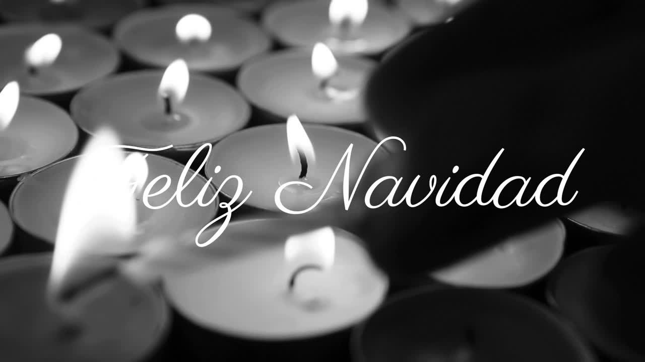 Feliz Navidad text over burning candles in black and white animation