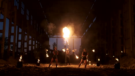 A-group-of-professional-artists-with-fire-show-the-show-juggling-and-dancing-with-fire-in-slow-motion