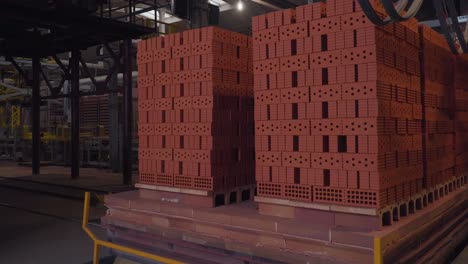 stacked red bricks in a factory