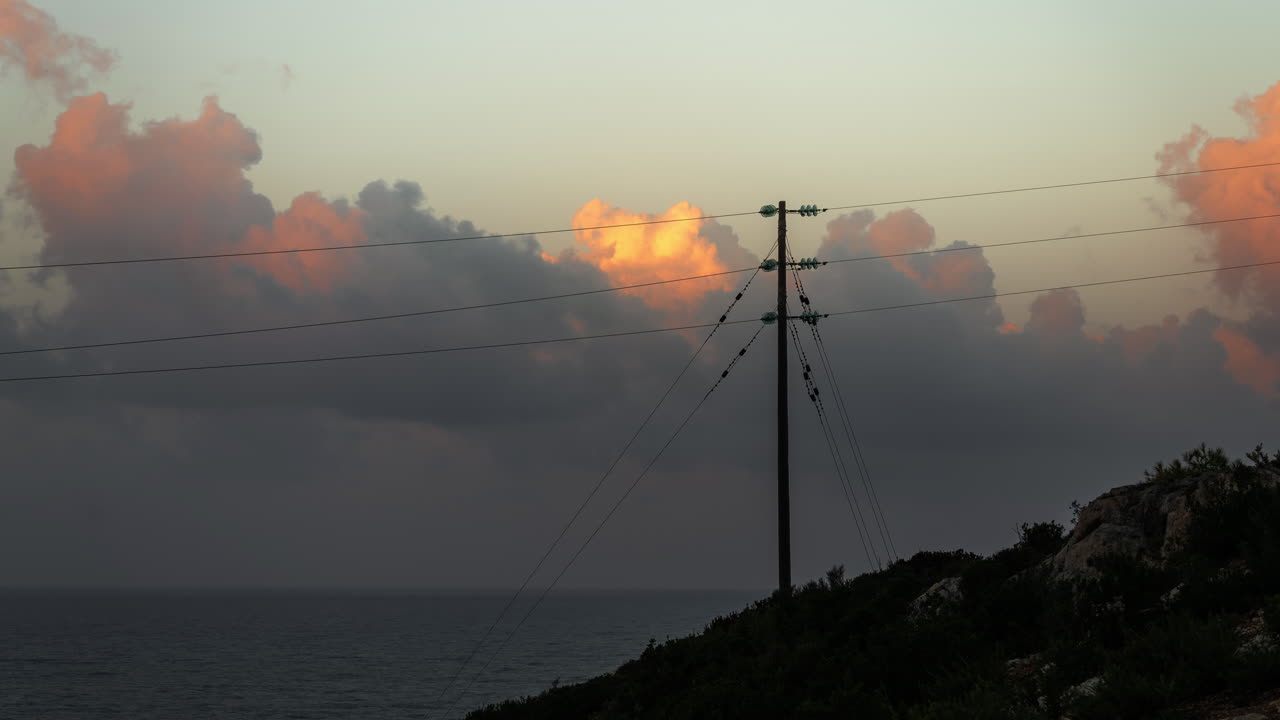 Sunset over the Sea with Power Lines