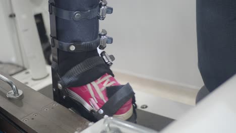 person's leg in a rehabilitation brace on a therapy machine