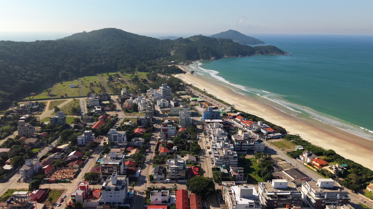Amazing drone view over the beautiful Mariscal beach line on a coastal settlement, Santa Catarina, Brazil