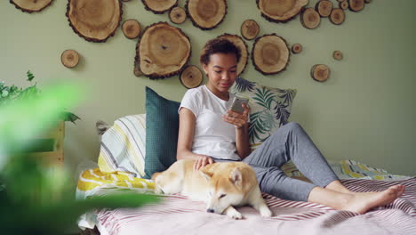 teenage girl relaxing with her dog on the bed