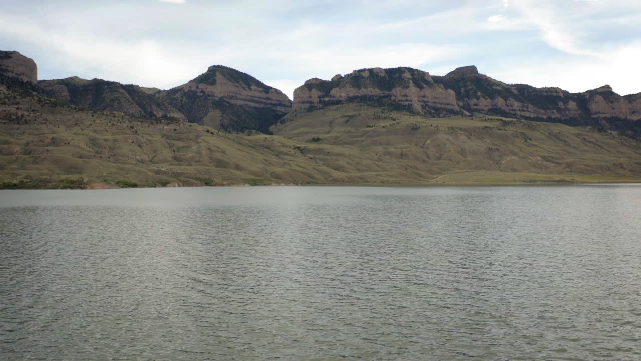 Scenic View of a Lake with Rugged Mountains Under a Cloudy Sky