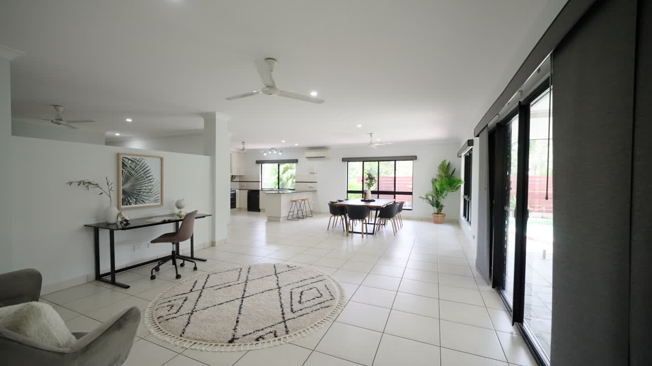 Reveal Past Wall of Home Interior From Front Entrance To Open Plan Lounge Room and Dining Kitchen Areas
