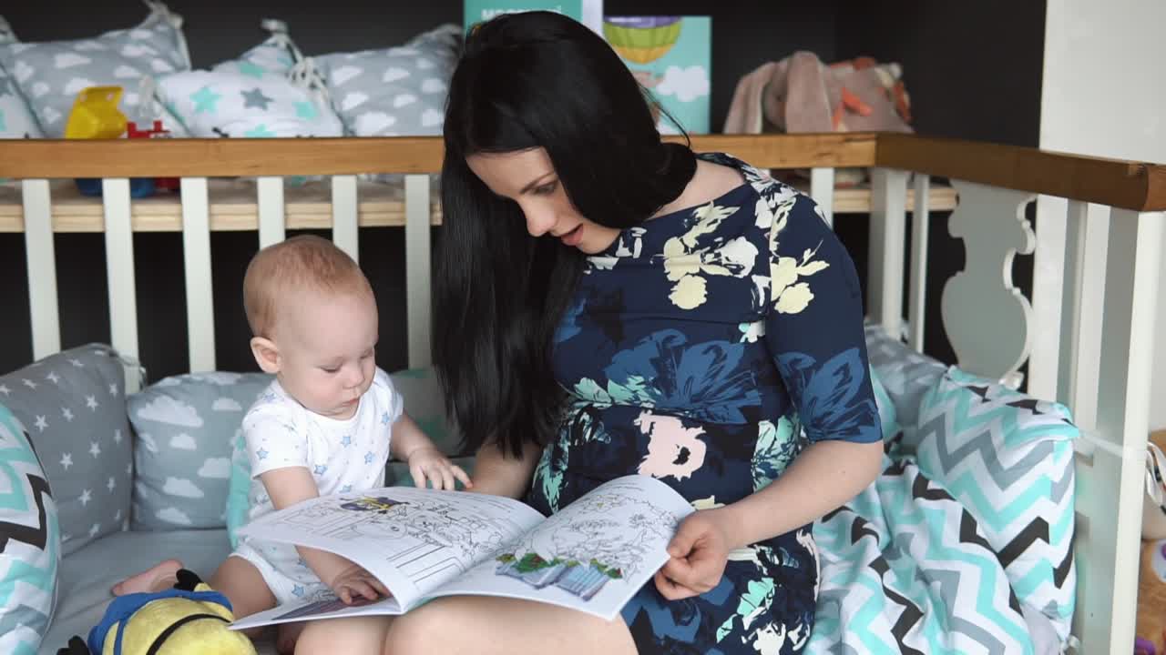 Mother Reading to Baby in Crib